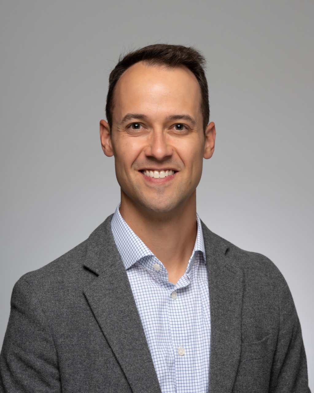 Steve Lindsey smiling in a gray blazer